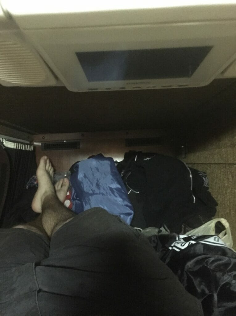 The inside of a bunk in a Prevost XLII-45VIP touring coach bus.